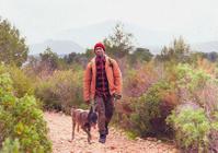 Man hiking with his dog beside him outdoors