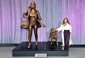 Mariska Hargitay standing next to the Courageous Together Statue