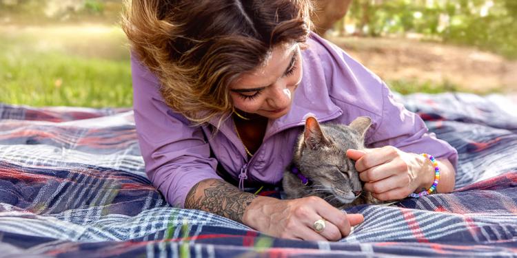 woman laying with gray cat