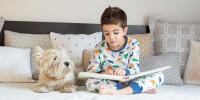 A boy is reading to dog