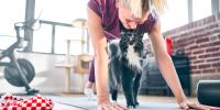 cat and woman on yoga mat
