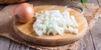 whole and chopped onion on cutting board