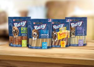 A lineup of Busy Bone Dog Chew Treats packages.