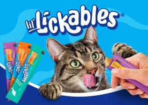 Tabby cat eagerly reaching for a Friskies Lil' Lickables creamy treat held by a hand, with three Lil' Lickables pouches and the product logo displayed on a bright blue background.