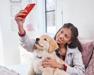A human taking a selfie with their puppy.